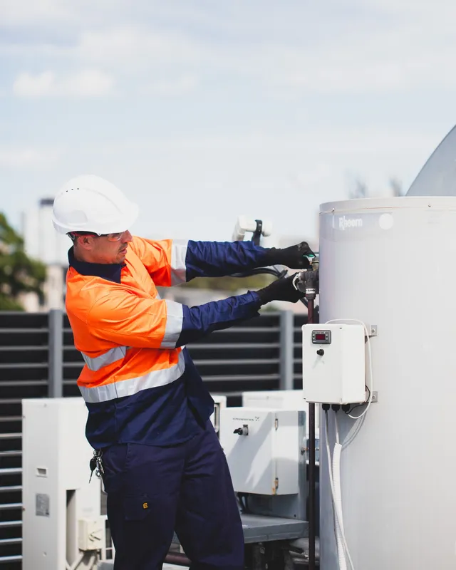Technician working on a commercial hot water system